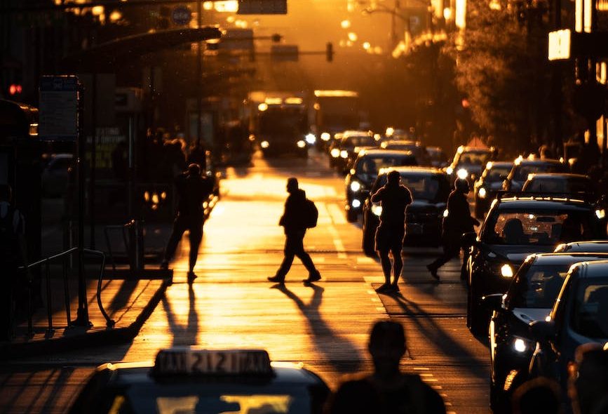 people walking on street during golden hour