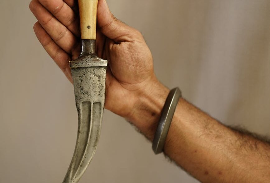 a person holding sharp pointed knife