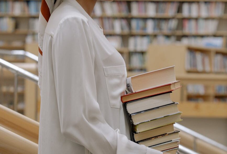 hands woman books faceless